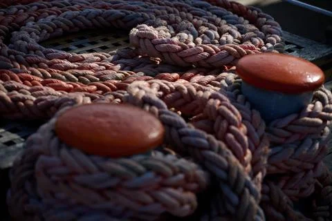Close up view of thick coiled mooring rope on a wooden ship deck, Gdynia, Pom Stock Photos