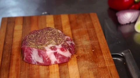 Close up view on thick piece of beef steak raw meat with spices and seasoning on Stock Footage 105457018