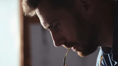 Close up view of thoughtful attractive young bearded man working hard on the Stock Footage 105673869