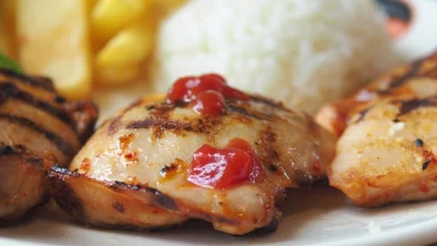 A close-up view of three chicken cutlets with ketchup served alongside rice.. Stock Footage 332140988