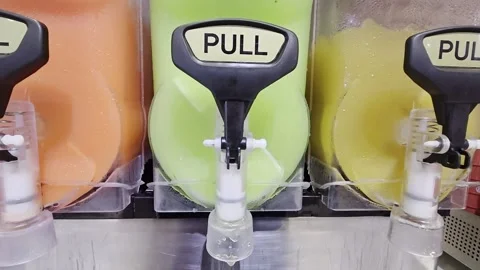 Close-up view of three flavors of slushie dispensers Stock Footage 323866736