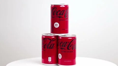 Close up view of three metal can of sugar-free Coca-Cola rotate in background. Stock Footage 225285262