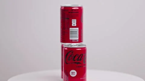 Close up view of three metal cans of sugar-free Coca-Cola rotate in background. Stock Footage 227196789