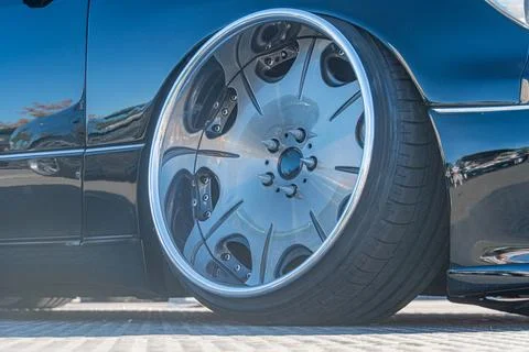 Close-up view of a three-quarter angle car wheel, with a silver or chrome fin Stock Photos
