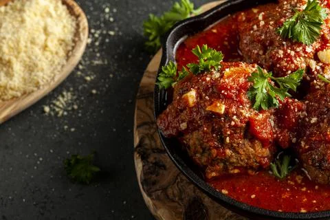 Close up view of three traditional large Italian meatballs in sizzling tomato Stock Photos