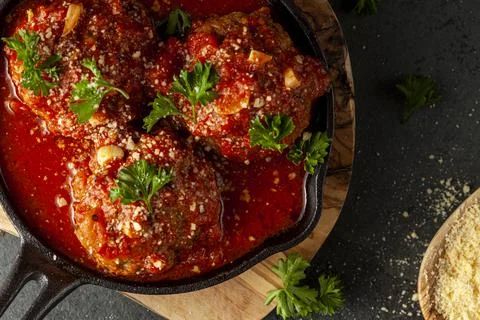 Close up view of three traditional large Italian meatballs in sizzling tomato Stock Photos