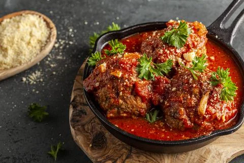 Close up view of three traditional large Italian meatballs in sizzling tomato Stock Photos