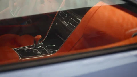 Close up view through a car window revealing a luxury vehicle interior with 스톡 동영상 329402659