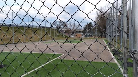 Close Up View Through Chain Link Fence Of Urban Soccer Field 스톡 사진