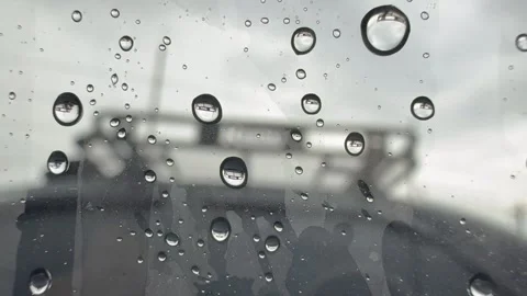 Close-up view through a driver’s side car window with large raindrops. Stock Footage 345838779