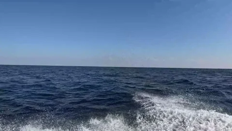 A close-view of Tidal waves captured from the boat over the deep blue waves. Stock Footage 295907529