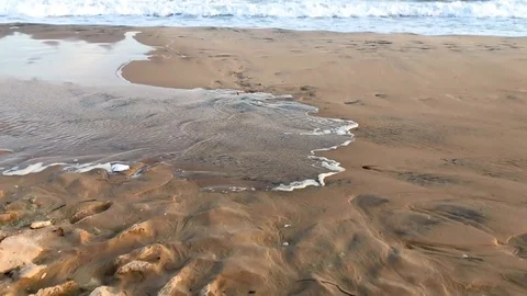 Close view of tide coming in on a sand beach Stock Footage 126815606