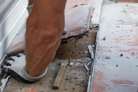 Close view of tile demolition with debris, dust and exposed flooring base bes Stock Photos
