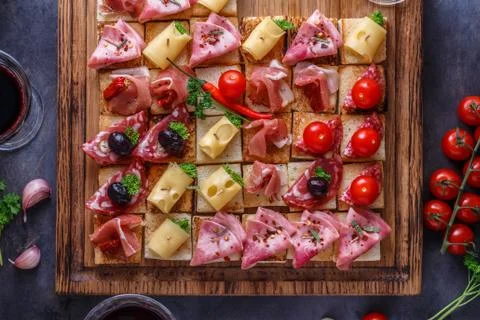 Close view of tiny bruschettas with prosciuto, ham and cheese Stock Photos