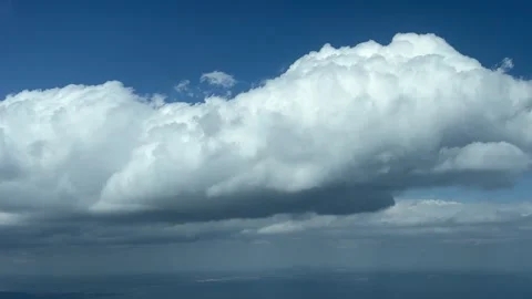 Close-up view of a tiny cumulus cloud shot from a jet cabin during the Stock Footage 241882417