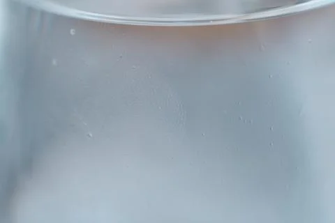 Close-up view of tiny sparkling water bubbles adhering to the inside of a gla Stock Photos