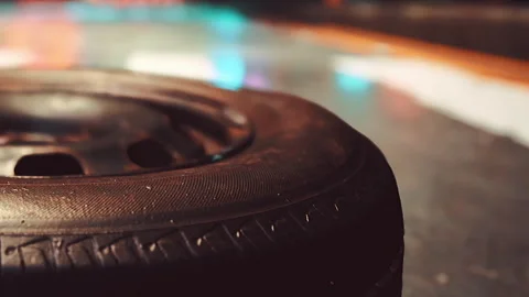Close up view of a tire on a racing track in a busy arena Stock Footage 342039709