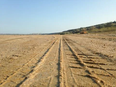 Close up view of tire tread marks on some beach sand Stock Photos
