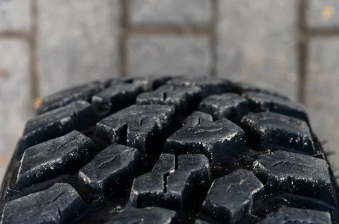 Close-up view of a tire tread pattern on a paved surface Stock Photos