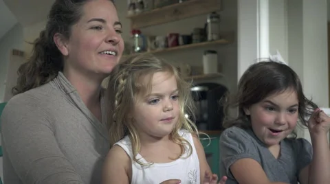 Close up view of a toddler with her sibling and parent (1 of 2) Stock Footage 48706216
