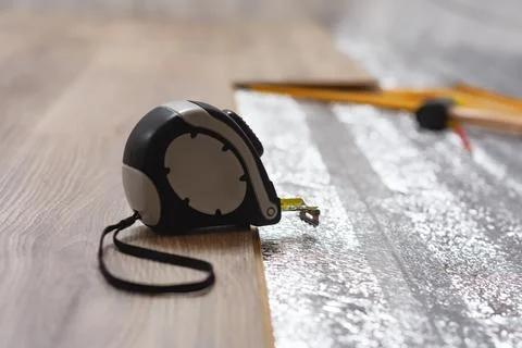 Close-up view of tools and materials used for laminate flooring installation. Stock Photos