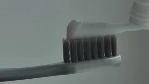 Close up view of toothpaste with Gray toothbrush Stock Footage 230088544