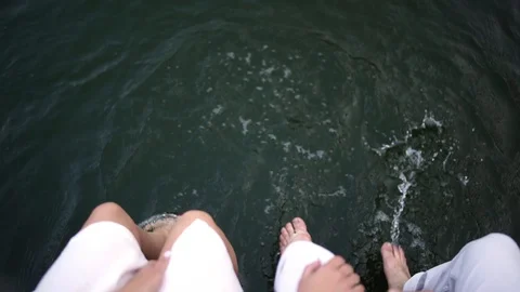 Close up. А view from the top. Man and woman kick in the water. Stock Footage 129114700