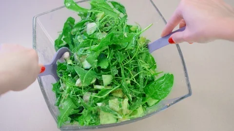 A close-up view of the top, Slow Motion, a salad in a glass salad bowl made from Stock Footage 101635398