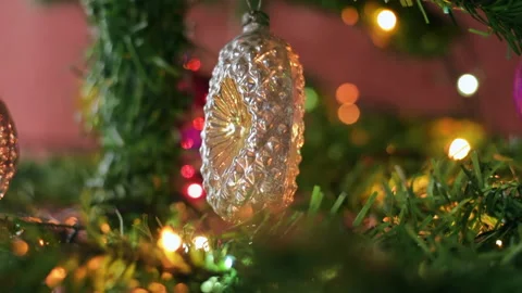 Close view of a toy hanging on an artificial Christmas tree with illumination Stock Footage 221129009