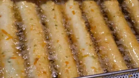 Close up view of traditional Korean fish cake sticks frying in hot bubbling oil Stock Footage 337374898