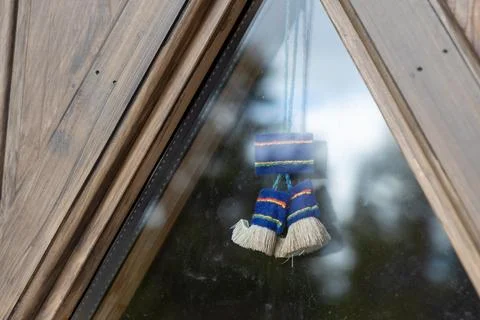A close-up view of a traditional Saami textile decoration hanging from a tria Fotos de archivo