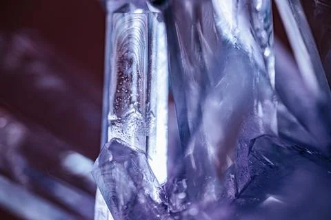 Close-up view of translucent quartz crystals illuminated with purple light,.. Stock Photos