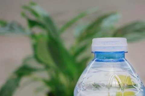 Close up view of transparent blue plastic water bottle with white tethered .. Stock Photos