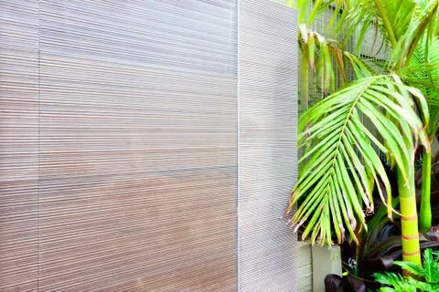 Close view of a tuned off wall waterfall near to the green trees. Stock Photos