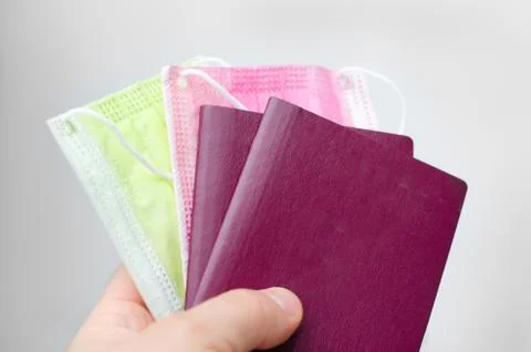 Close up view of a  two  blank  passport cover  and     face  mask  on a whit Stock Photos