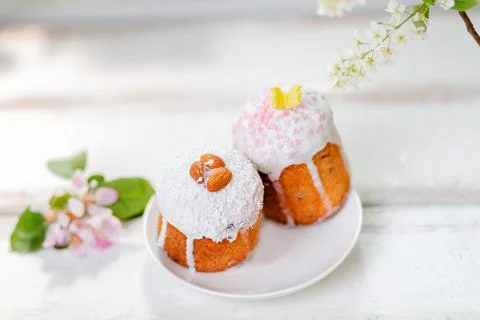Close up view of two decorated easter cakes on a plate with apple blossom. To Stock Photos