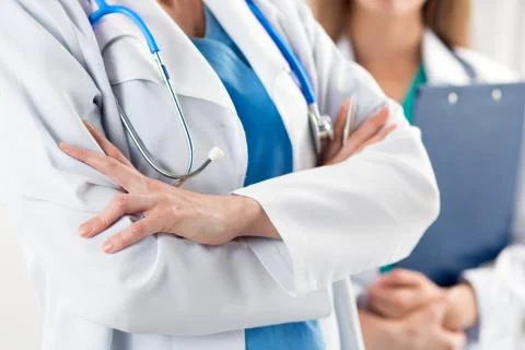 Close up view of two doctors standing with their arms crossed Stock Photos