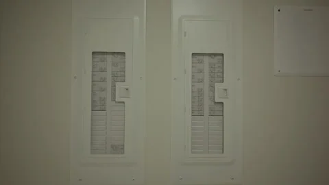Close-up view of two electrical breaker panels mounted on an indoor wall, used Stock-Footage 317062566