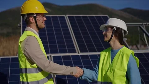 Close up view of two engineer male and female wearing safety vest handshake with Stock Footage 289020708