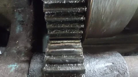 Close-up view of two gears interlocking and rotating Stock Footage 306981401