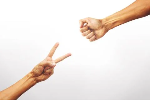 Close-up view of two hands playing rock paper scissors in a whit Stock Photos