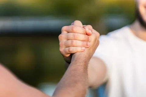 Close up view of two men shaking hands outdoors Stock Photos