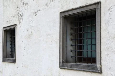 Close-up view of two old windows with thick metal bars Fotos de archivo