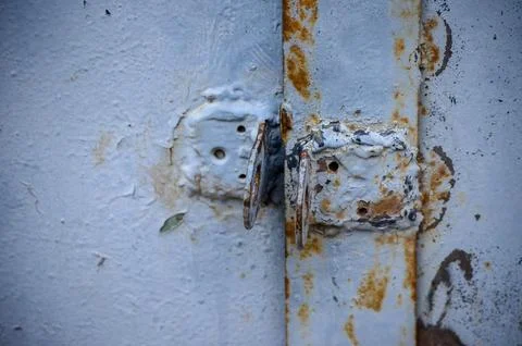 Close-up view of two rusty old welded metal eyelets. Foto stock