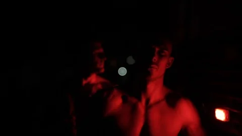 Close view of two serious handsome young men standing near a fire engine in the Stock Footage 120440313