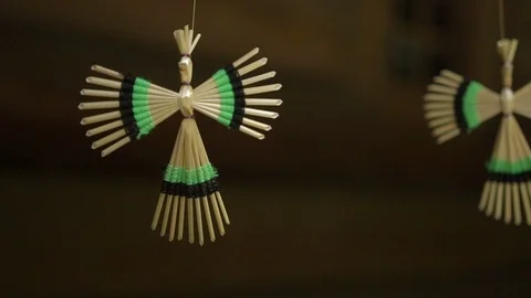 Close-up view of the two straw handmade dolls hanging on the string. Angle Stock Footage 87870355