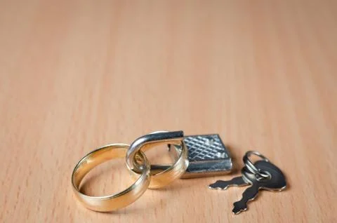 Close up view of  two wedding rings closed with a padlock representing a conc Stock Photos