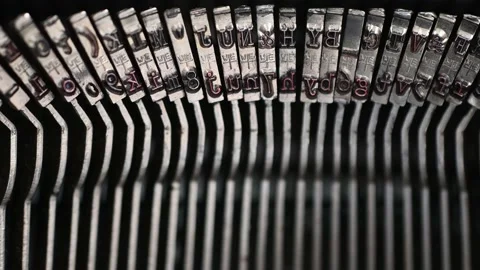 Close view of typebars of the vintage typewriter while typing a text. Stock Footage 151610375
