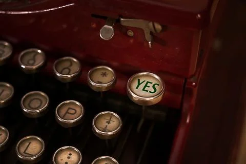 Close up view of a typewriter keyboard. Focus on the key "YES". Stock Photos
