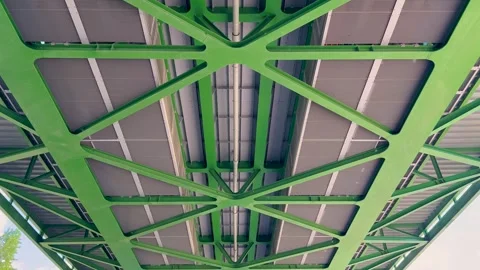 A close-up view of the underside of a green steel bridge, showcasing 動画素材 299946372